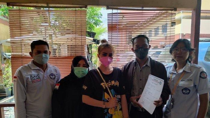 Lilis (baju kaos hitam bercorak) didampingi pihak TRC PPA Kaltim saat melakukan pelaporan ke Mapolresta Samarinda