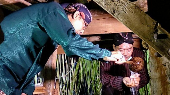 RM Kukuh Hertriasning (kiri) memberikan air dari Gentong Kyai Suba pada Joko Narendro, tokoh masyarakat asal Pengkol, Nglipar, Gunungkidul pada Rabu (19/08/2020) malam. Kegiatan ini merupakan bagian dari ritual Kirab Pusaka dan Kuras Gentong, yang dilaksanakan setiap tahun menjelang 1 Muharram atau 1 Sura menurut penanggalan Jawa.