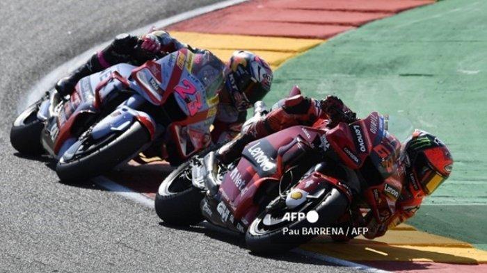 Francesco Bagnaia (depan) bersaing dengan Enea Bastianini. Keduanya kembali terlibat duel sengit pada MotoGP Jepang 2022, Minggu (25/9/2022). (Pau BARRENA / AFP)