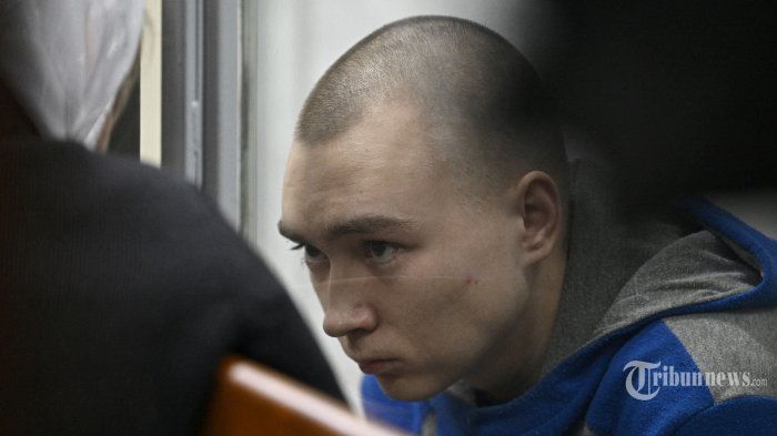 Tentara Rusia Vadim Shishimarin duduk di kotak terdakwa pada pembukaan persidangannya atas tuduhan kejahatan perang karena telah membunuh seorang warga sipil, di pengadilan distrik Solomyansky di Kyiv pada 18 Mei 2022. - Tentara yang ditangkap dituduh membunuh 62- warga sipil berusia satu tahun -- diduga sedang bersepeda -- di dekat desa Chupakhivka di timur laut wilayah Sumy Ukraina pada 28 Februari, pada hari-hari pertama serangan Rusia. Shishimarin mengaku bersalah dan menghadapi kemungkinan hukuman penjara seumur hidup di Kyiv. (Photo by Genya SAVILOV / AFP) (AFP/GENYA SAVILOV)