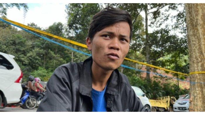 Ade menunggu Tim SAR Gabungan mencari jasad ibu dan adiknya di longsoran kawasan Cipanas.