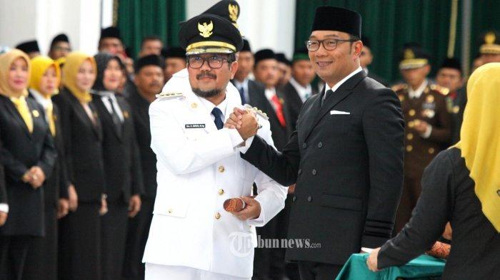 Gubernur Jawa Barat, Ridwan Kamil berjabatan tangan dengan Imron Rosyadi (kiri) seusai dilantik menjadi Bupati Cirebon di Aula Barat Gedung Sate, Jalan Diponegoro, Kota Bandung, Selasa (1/10/2019).