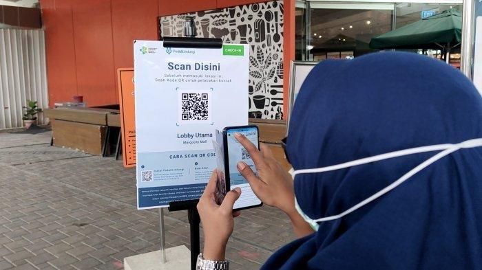 Pengunjung melakukan scan barcode aplikasi PeduliLindungi sebelum memasuki Margo City Mall, Rabu (18/8/2021)
