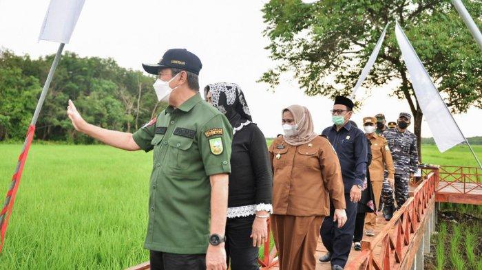 Gubernur Riau Syamsuar melambaikan tangan kepada warga saat berkunjung ke Desa Mentayan, Kabupaten Bengkalis, Senin (6/9/2021) sore